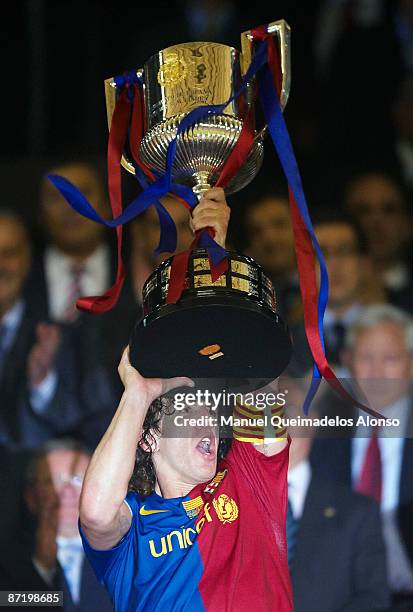 Carles Puyol of Barcelona raises the cup after the Copa del Rey final match between Barcelona and Athletic Bilbao at the Mestalla stadium on May 13,...