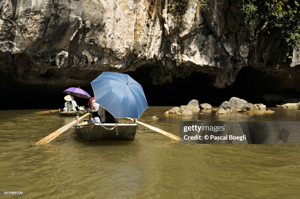 Boats at the entrance of a cave in Tam Coc, Ninh Bình Province, Vietnam