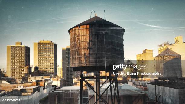 rooftops of manhattan, with iconic water storage tanks, in the soho area. new york city, usa - west village foto e immagini stock