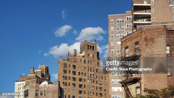 geometries of different residential buildings along 7th avenue in the west village, manhattan, new york city - hunter, new york stock-fotos und bilder