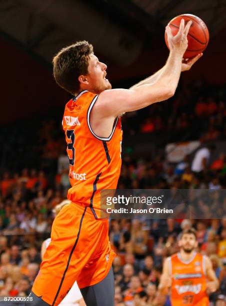 Cameron Gliddon of the Taipans flicks the ball back over his head to score a basket during the round six NBL match between the Cairns Taipans and...