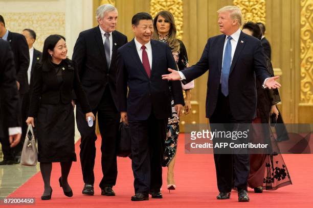 President Donald Trump gestures toward China's President Xi Jinping , as US First Lady Melania Trump is seen in the background, in the Great Hall of...