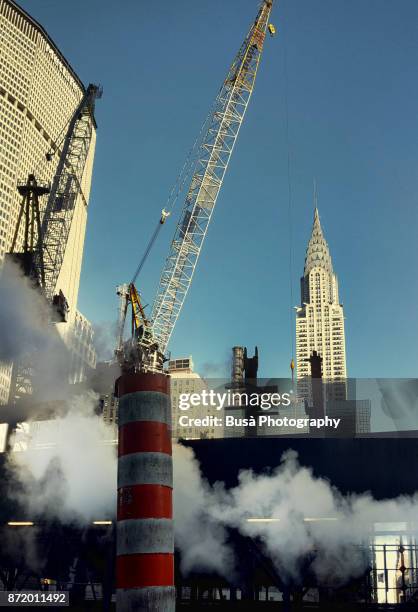 construction site with tall cranes near grand central terminal along east 42nd street, with the metlife building and the chrysler building in the background. midtown manhattan, new york city - the chrysler building and grand central station stock pictures, royalty-free photos & images