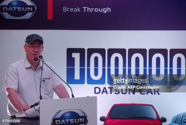 And Managing Director of Renault Nissan Automotive India Colin MacDonald speaks during the launch of the Datsun redi-Go car that will mark the...