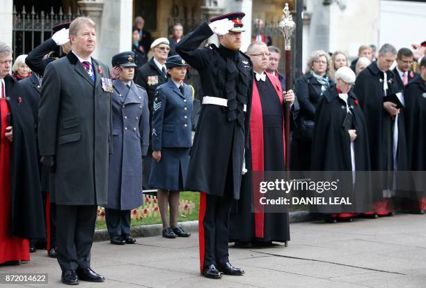 Britain's Prince Harry salutes after laying a Cross of Remembrance in front of wooden crosses from the Graves of Unknown British Soldiers from the...