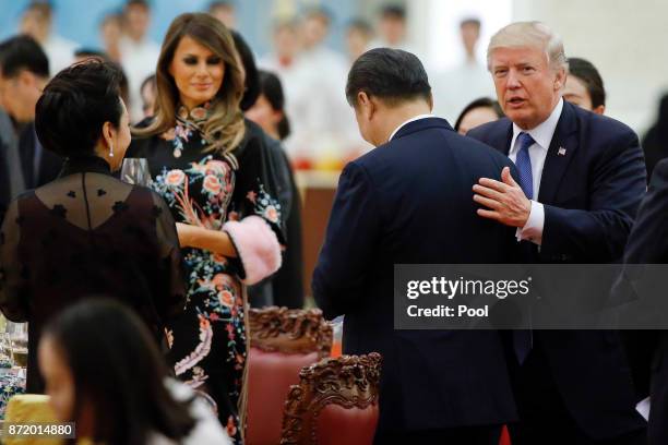 President Donald Trump talks to China's President Xi Jinping during a state dinner at the Great hall of the People on November 9, 2017 in Beijing,...