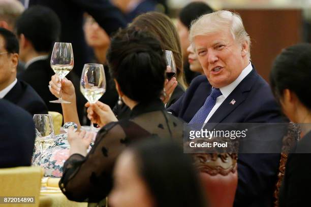 President Donald Trump makes a toast during a state dinner hosted by his Chinese counterpart Xi Jinping at the Great hall of the People on November...