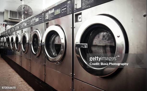 row of washers in laundromat in brooklyn, new york city, usa - money laundery stock pictures, royalty-free photos & images