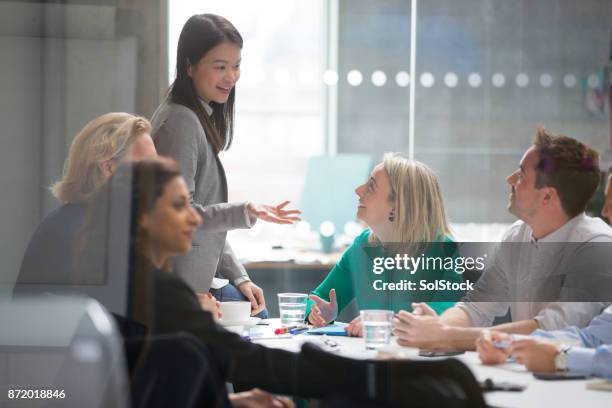 female holds a successful business meeting - business meeting chinese stock pictures, royalty-free photos & images