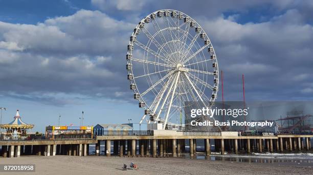 will steel pier's observation wheel on the waterfront in atlantic city, new jersey - atlantic city steel pier stock pictures, royalty-free photos & images