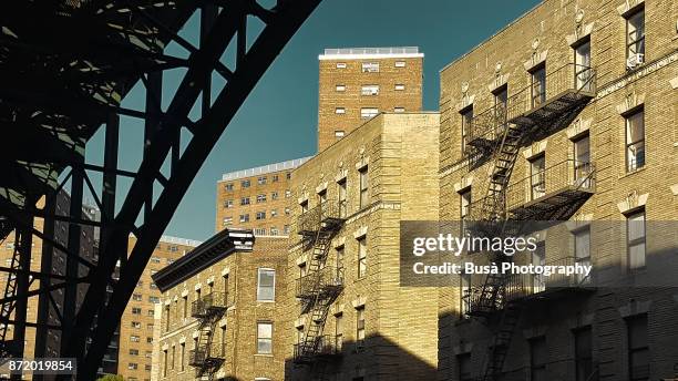 residential buildings as seen from under the riverside drive viaduct, at 125th street and 12th avenue, harlem, manhattan - harlem slum stock pictures, royalty-free photos & images