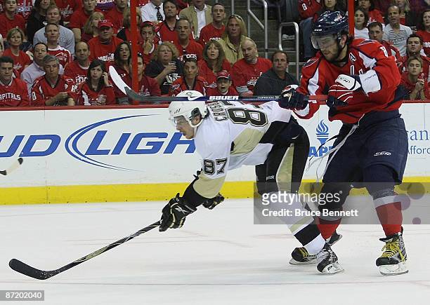 Alex Ovechkin of the Washington Capitals checks Sidney Crosby of the Pittsburgh Penguins during Game Seven of the Eastern Conference Semifinal Round...