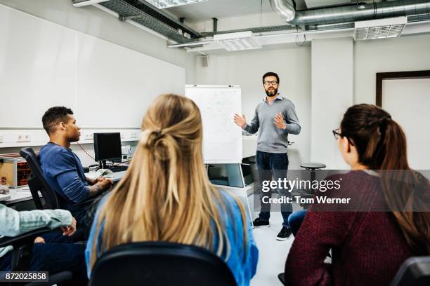 engineering tutor explaining concept during university seminar - wisdom knowledge modern stockfoto's en -beelden