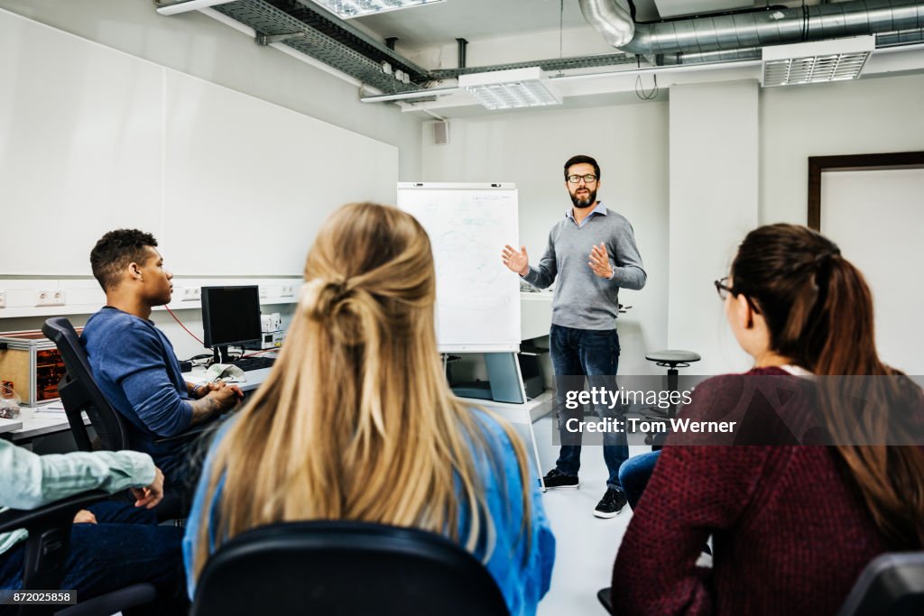 Engineering Tutor Engineering Tutor Explaining Concept During University Seminar High-Res ...