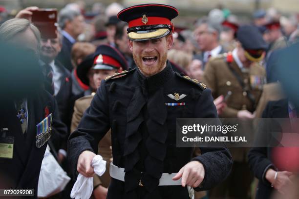 Britain's Prince Harry reacts as he talks with veterans and serving members of the armed forces during his visit to the Field of Remembrance at...