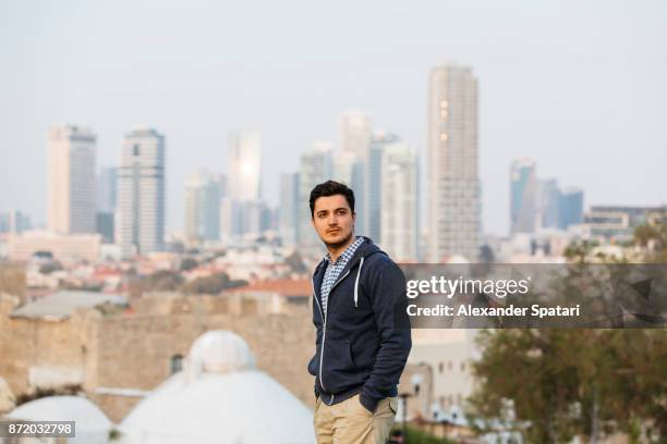 young man with tel aviv skyline background - israel people stock pictures, royalty-free photos & images