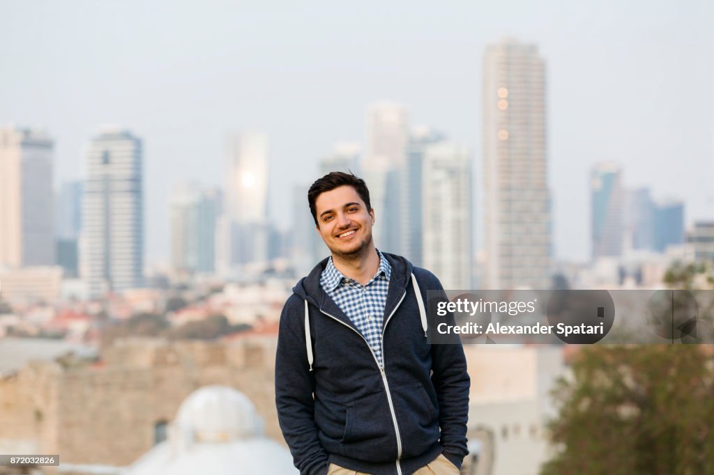 Young man with Tel Aviv skyline background