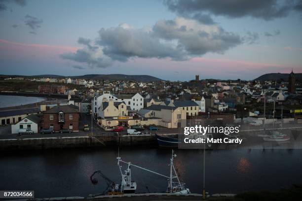 Lights are turned on as night falls on November 7, 2017 in Peel, Isle of Man. The Isle of Man is a low-tax British Crown Dependency with a population...