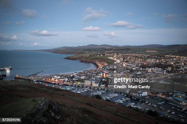 Lights are turned on as night falls on November 7, 2017 in Peel, Isle of Man. The Isle of Man is a low-tax British Crown Dependency with a population...