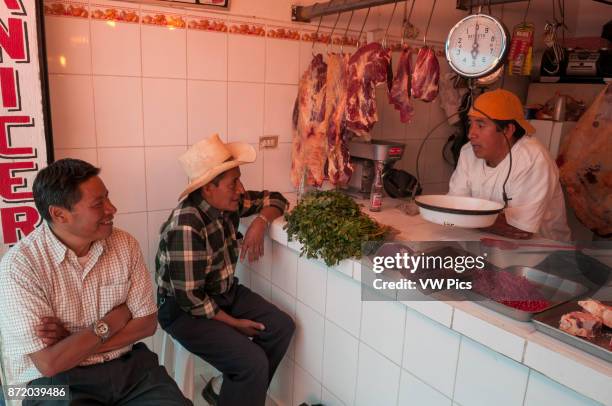 People chatting with the butcher in Salcaja.