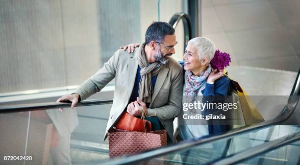black friday - couple walking shopping stock-fotos und bilder