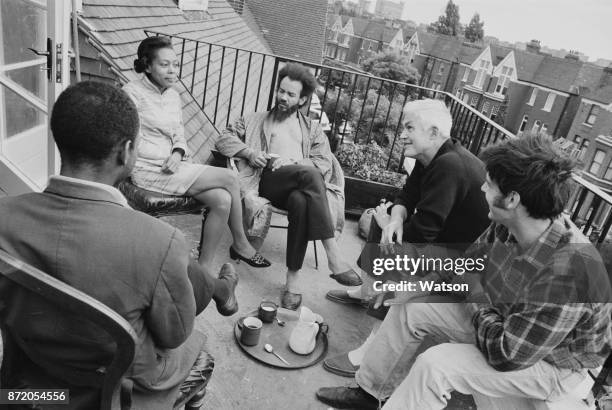 Revolutionary and civil rights activist Michael de Freitas, Michael X , on the balcony of his home with some friends, including English novelist and...