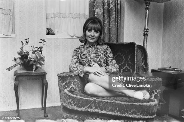 Scottish singer-songwriter and television personality Lulu sitting on a patterned armchair, UK, 29th July 1967.