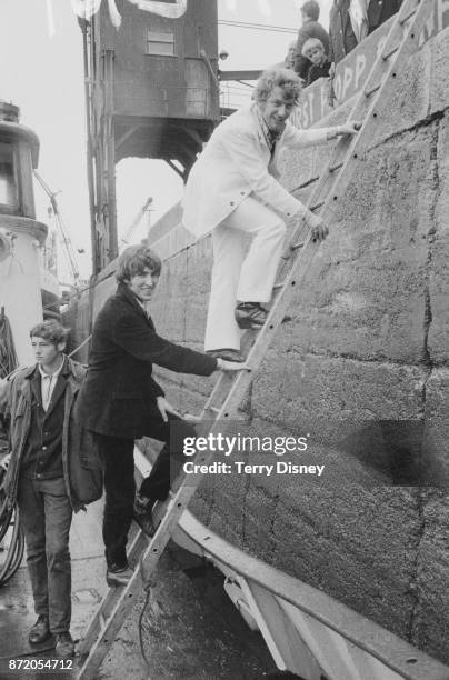 Disc jockeys Robbie Dale and Johnnie Walker of offshore pirate radio 'Radio Caroline' arrive at Felixstowe, UK, 15th August 1967.