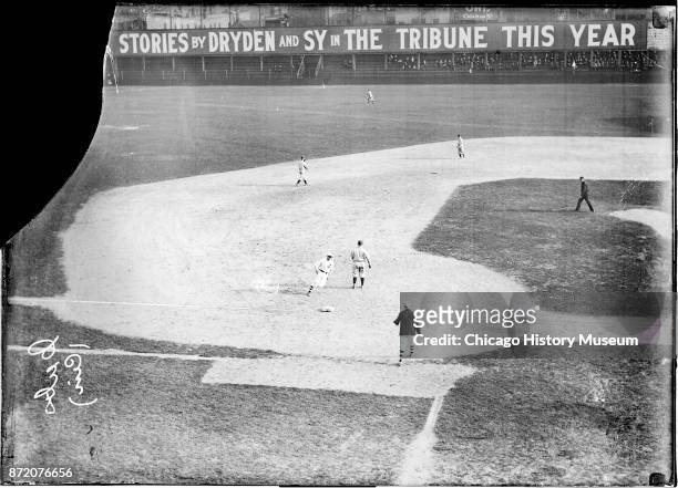 An unidentified Chicago Cubs baseball player runs to third base during a game against the Cincinnati Reds at West Side Grounds, Chicago, Illinois,...