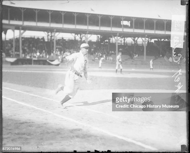 Baseball player Joe Tinker , of the Chicago Cubs, approaches first base during a game at West Side Grounds, Chicago, Illinois, 1908.