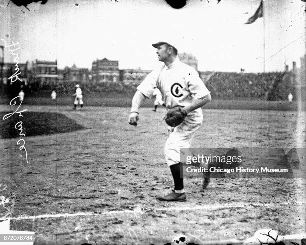 Baseball player Frank Chance , of the Chicago Cubs, throws a ball on the field at West Side Grounds, Chicago, Illinois, 1908.