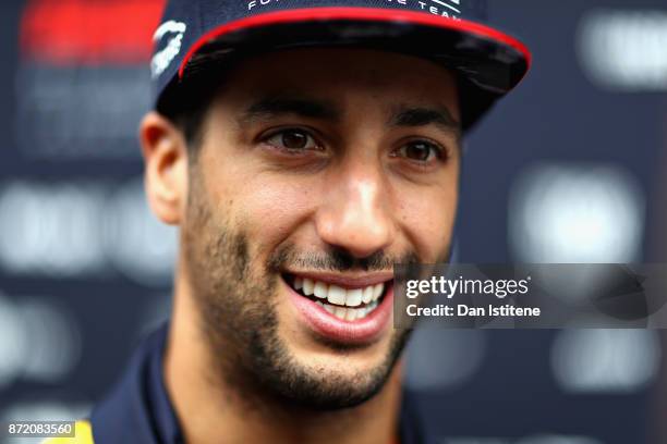 Daniel Ricciardo of Australia and Red Bull Racing talks in the Paddock during previews for the Formula One Grand Prix of Brazil at Autodromo Jose...