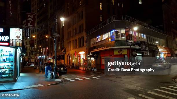 streets of lower manhattan at night. new york city, usa - small business exterior stock pictures, royalty-free photos & images