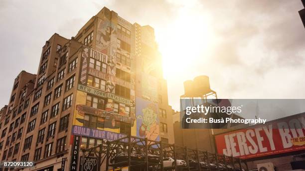 mural on industrial building in midtown manhattan along 8th avenue and west 44th street, new york city - new york street parking stock pictures, royalty-free photos & images