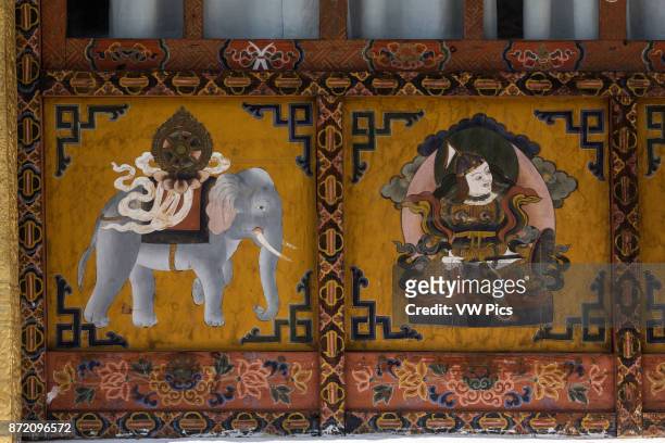 Buddhist religious paintings, including a Dharma Wheel on the back of an elephant on the Buddhist temple in Punakha, Bhutan.