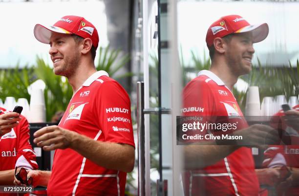Sebastian Vettel of Germany and Ferrari talks in the Paddock during previews for the Formula One Grand Prix of Brazil at Autodromo Jose Carlos Pace...