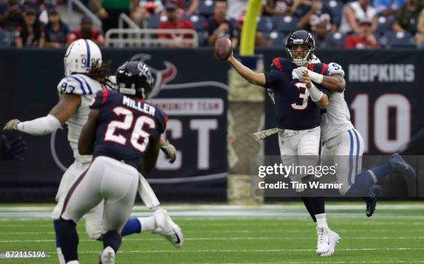 Tom Savage of the Houston Texans is pressured by Jon Bostic of the Indianapolis Colts in the first quarter at NRG Stadium on November 5, 2017 in...