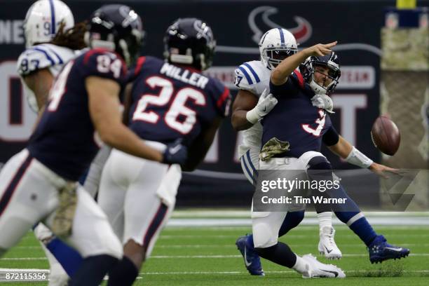 Tom Savage of the Houston Texans throws an incomplete pass under pressure applied by Jon Bostic of the Indianapolis Colts in the first quarter at NRG...