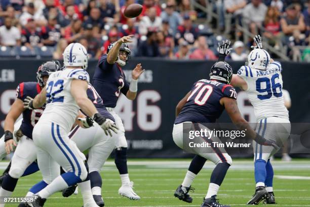 Tom Savage of the Houston Texans throws a pass under pressure by Henry Anderson of the Indianapolis Colts in the first quarter at NRG Stadium on...