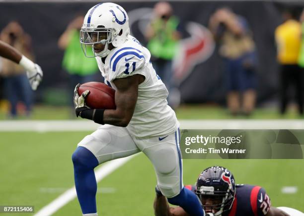 Quan Bray of the Indianapolis Colts returns a punt defended by Jordan Todman of the Houston Texans in the first quarter at NRG Stadium on November 5,...