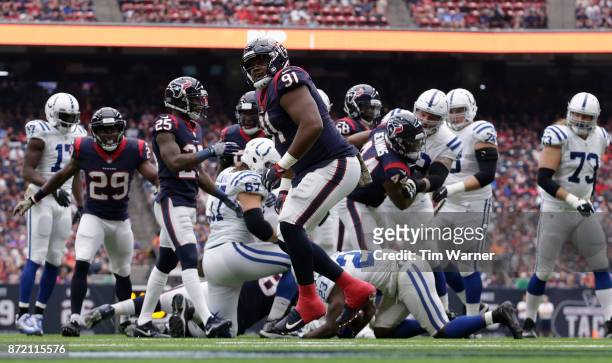 Carlos Watkins of the Houston Texans celebrates after tackling Frank Gore of the Indianapolis Colts for a loss in the first quarter at NRG Stadium on...
