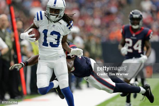 Hilton of the Indianapolis Colts is forced out of bounds by Andre Hal of the Houston Texans in the second quarter at NRG Stadium on November 5, 2017...