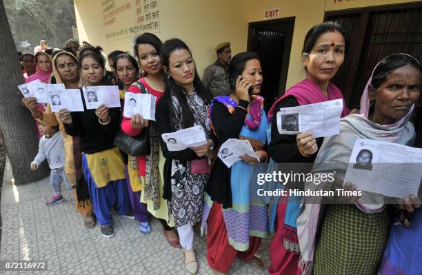 Voters in queue waiting for their turn to cast their vote at polling station Jadla for Doon Constituency on November 9, 2017 in Arki, India.