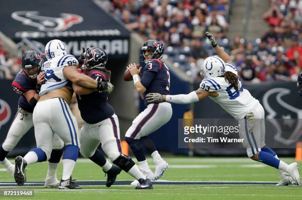 Tom Savage of the Houston Texans looks to pass under pressure by Jabaal Sheard of the Indianapolis Colts in the third quarter at NRG Stadium on...