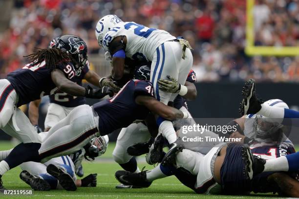 Marlon Mack of the Indianapolis Colts is tackled by Zach Cunningham of the Houston Texans in the second half at NRG Stadium on November 5, 2017 in...