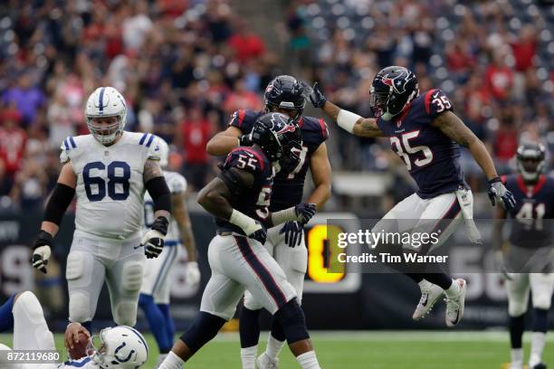 Benardrick McKinney of the Houston Texans celebrates with Eddie Pleasant and Brennan Scarlett after sacking Jacoby Brissett of the Indianapolis Colts...