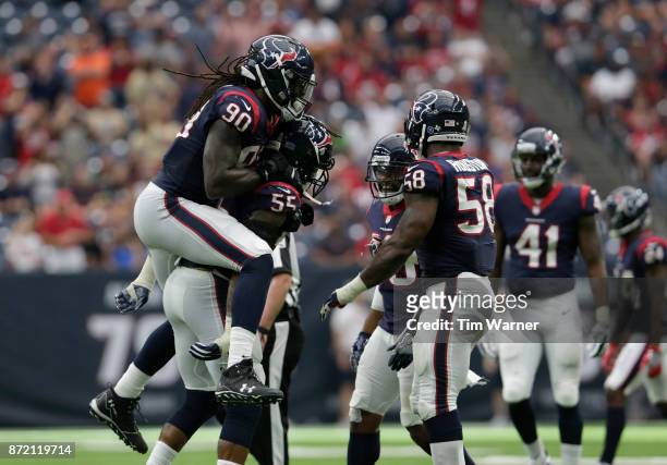 Jadeveon Clowney of the Houston Texans celebrates with Benardrick McKinney after a second half sack against the Indianapolis Colts at NRG Stadium on...