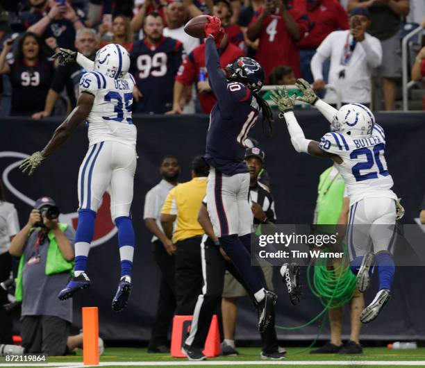 DeAndre Hopkins of the Houston Texans catches a pass which is ruled out of bounds in the fourth quarter defended by Pierre Desir of the Indianapolis...