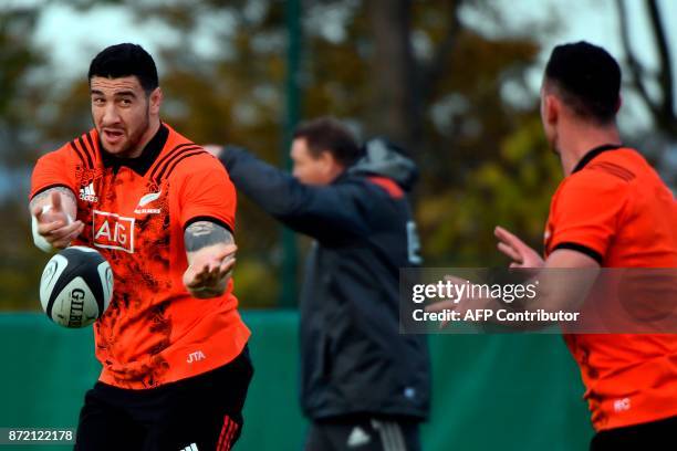 New Zealand's All Blacks hooker Codie Taylor passes the ball during a training session ahead of an upcoming test match against France, on November 9,...