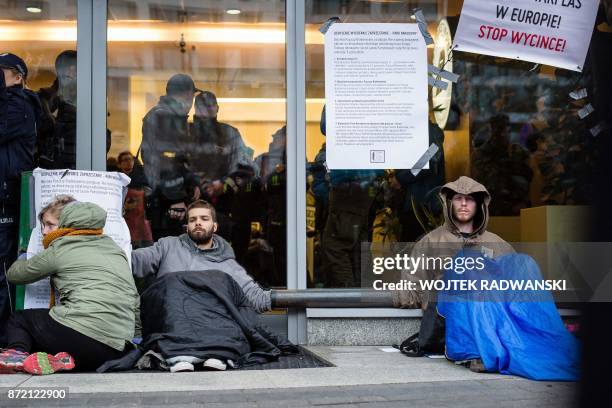 Enviromental activist have chained themselves at the entrance of headquarters of Poland's state forest management agency in protest against the...